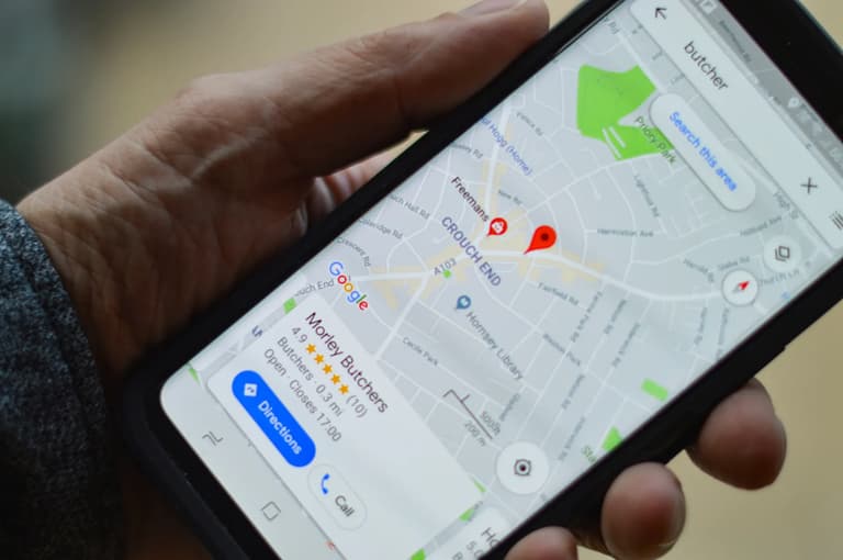 Phone showing a Google Maps business listing with star rating and directions